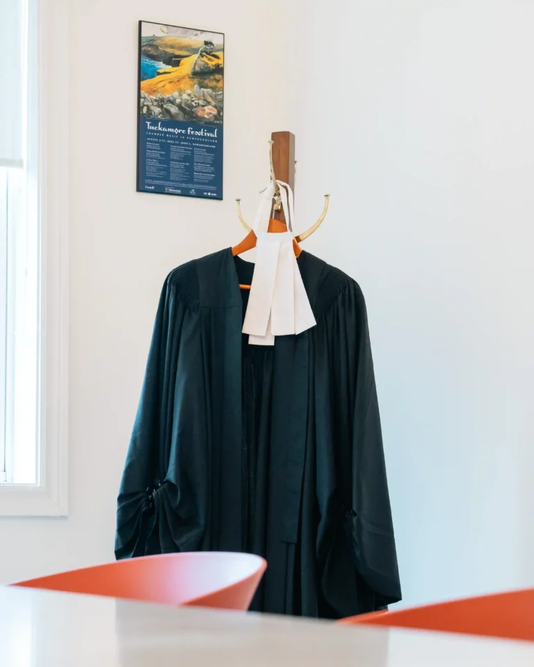 Barrister's uniform consisting of a black robe and white collar in the 'Saunders Collins and Loeb Law' office